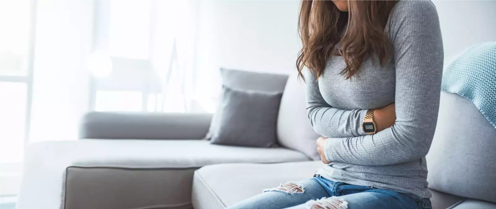 woman making a heart with her hands in front of her stomach