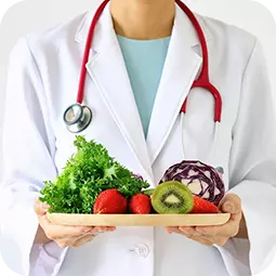 doctor holding tray of fruits and vegetables