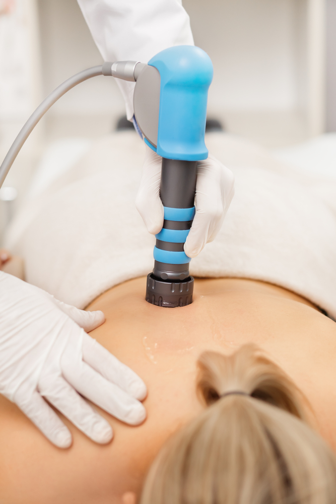 shockwave therapy on woman's back