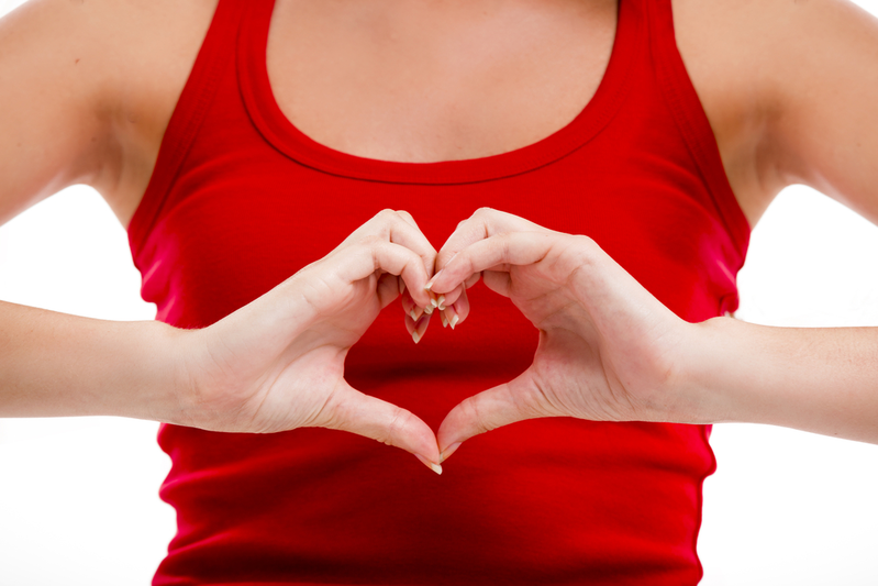 woman making heart over chest