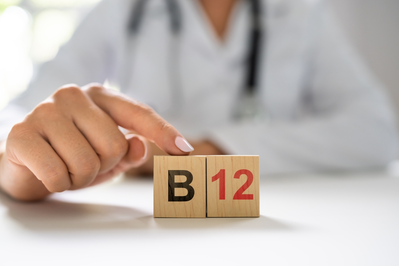 B12 blocks in front of doctor