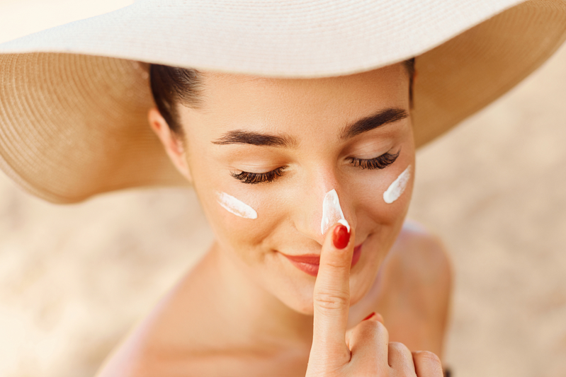 woman at beach wearing sunscreen
