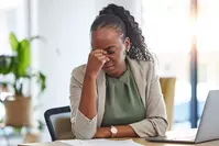 fatigued woman at desk