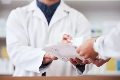 pharmacist giving patient medication