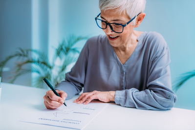 senior woman filling out papers