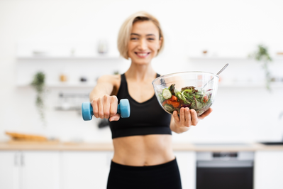 woman with weight and salad