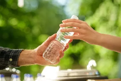 person taking water bottle