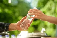 person taking water bottle