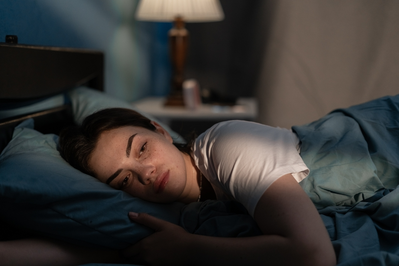 woman stressed laying in bed