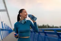 woman drinking water on run