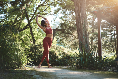 woman stretching in woods