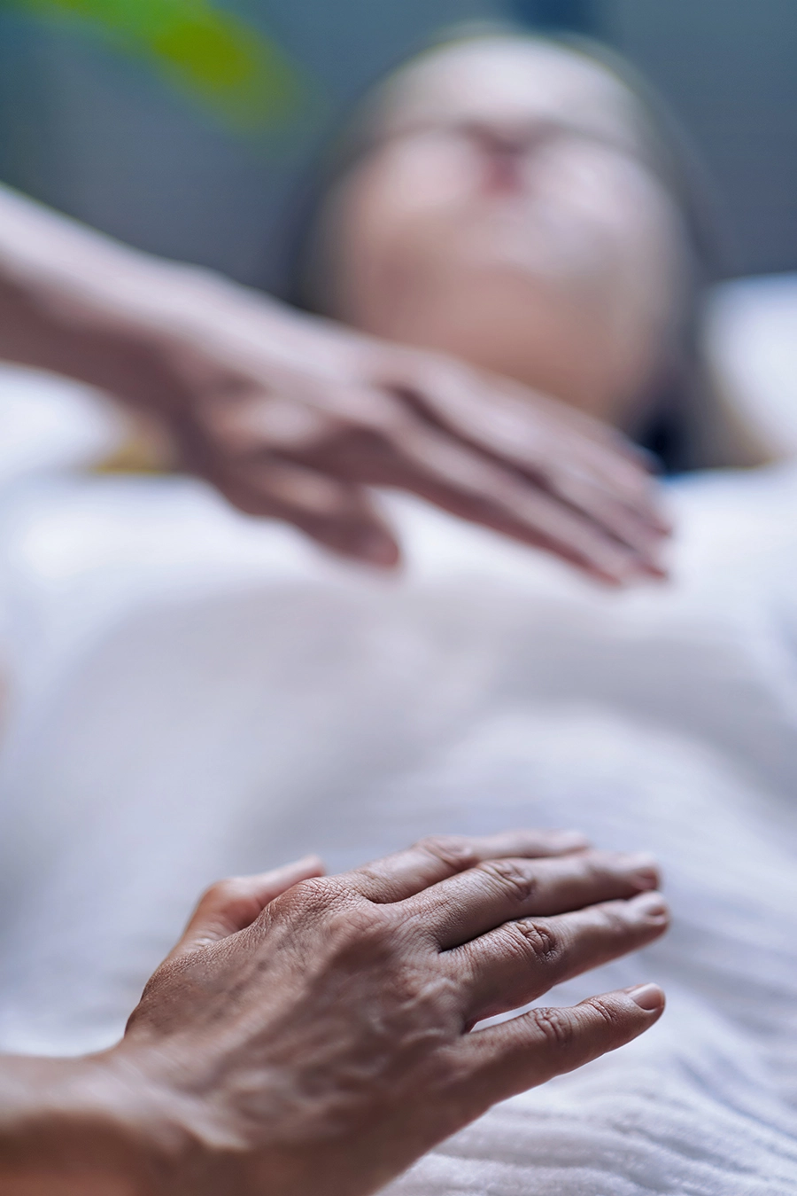 hands hovering above woman's body